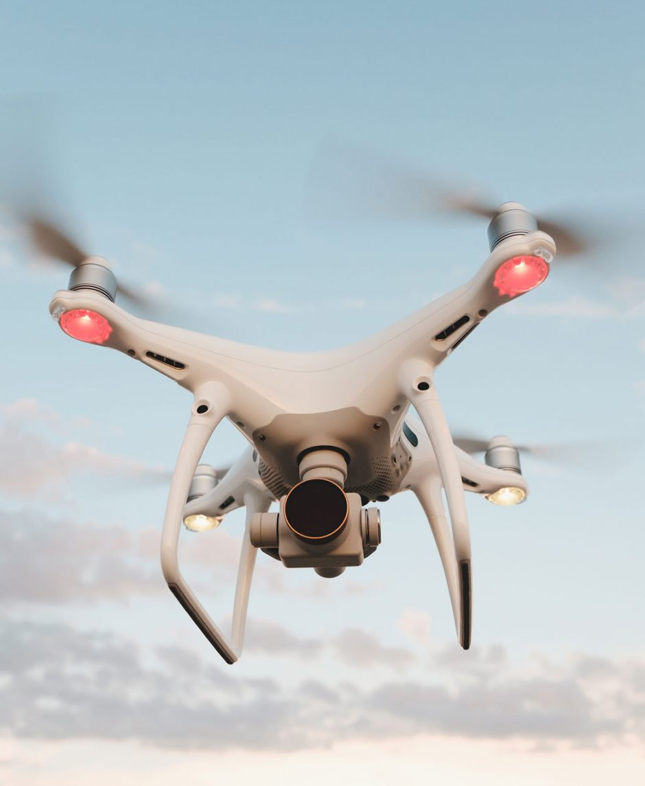 white-drone-hovering-in-a-bright-blue-sky-PMFRLG7.jpg